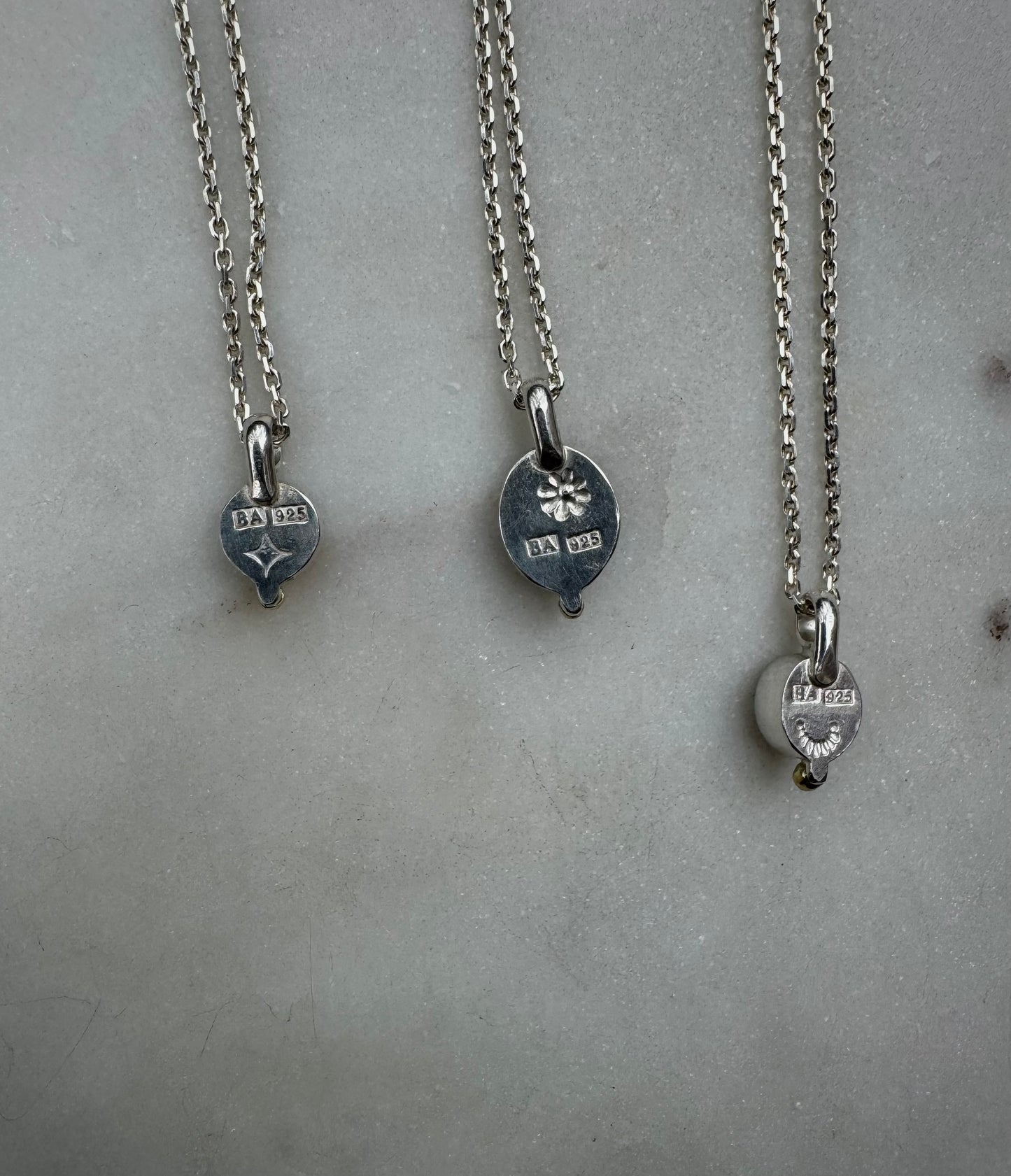 Small amulets with 18k gold