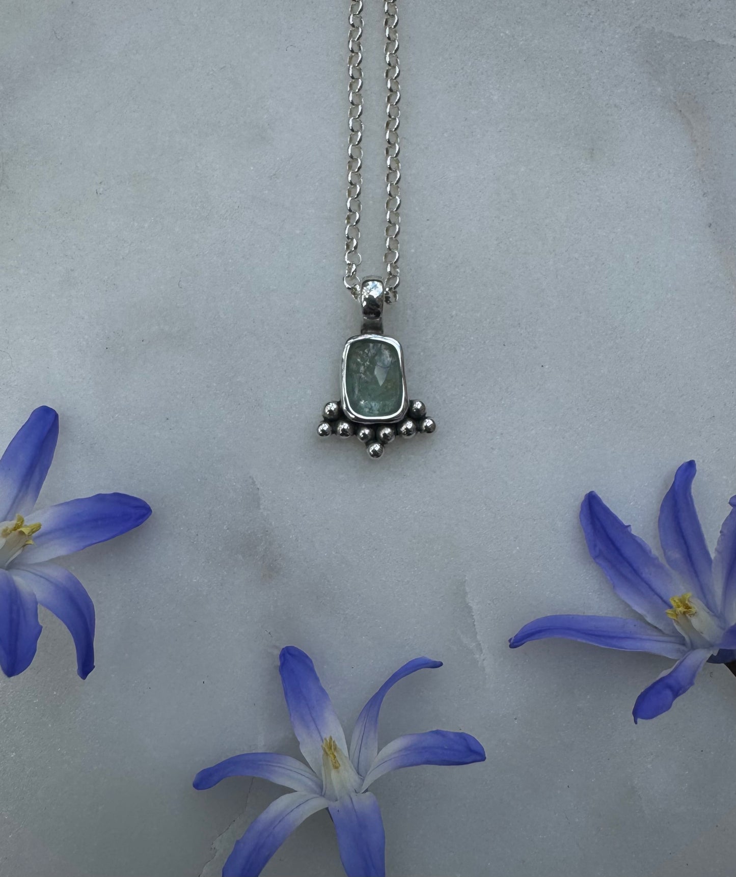 Small silver amulet with aquamarine