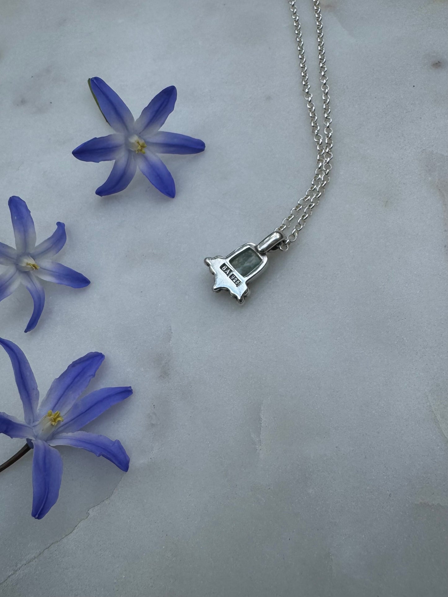 Small silver amulet with aquamarine