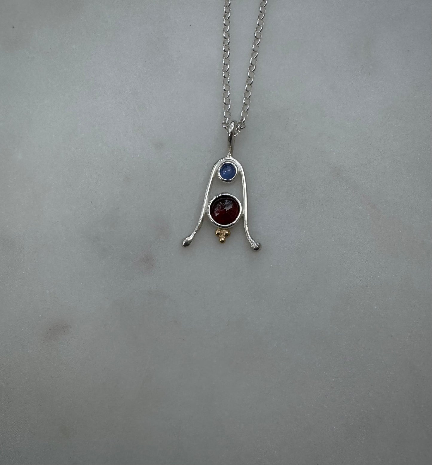 Amulet with Tanzanite, Garnet and 18k gold