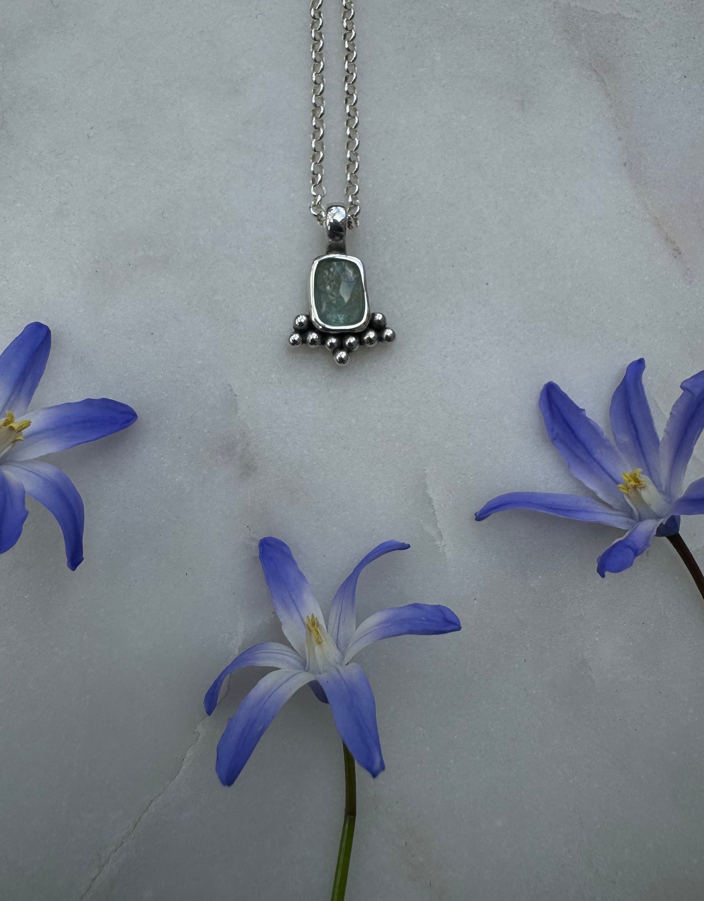 Small silver amulet with aquamarine